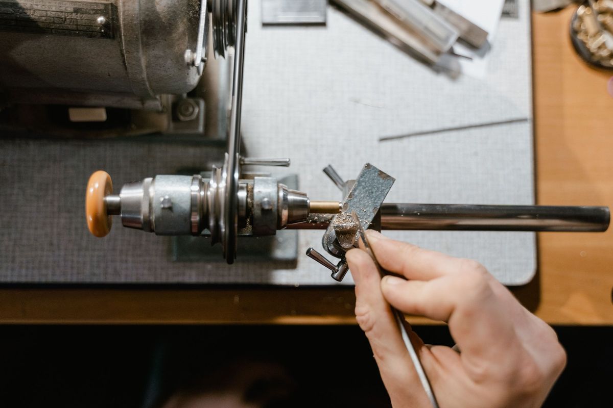 A jeweller cutting a wax model on a lathe