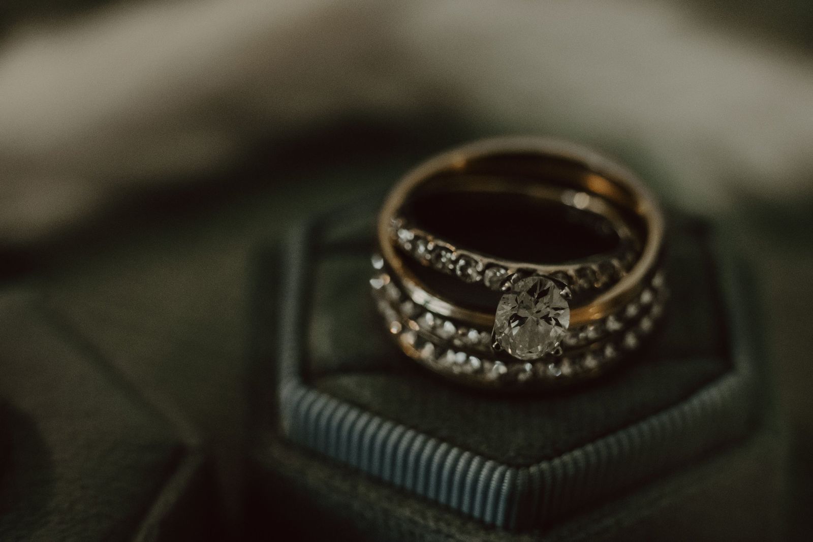 A stacked engagement ring and wedding band set on a hexagonal stand